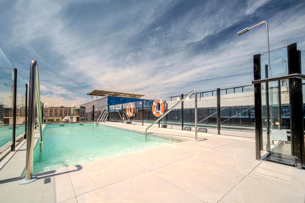 a swimming pool on the roof of a building at ITC Madrid by Soho Boutique in Madrid