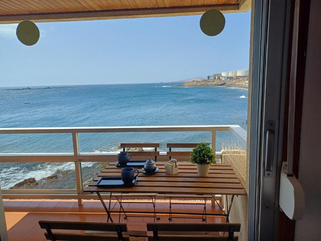 a table with a view of the ocean from a balcony at Sobre el Mar by CanariApartment, Oceanfront House with 3 Balconies in Salinetas in Telde