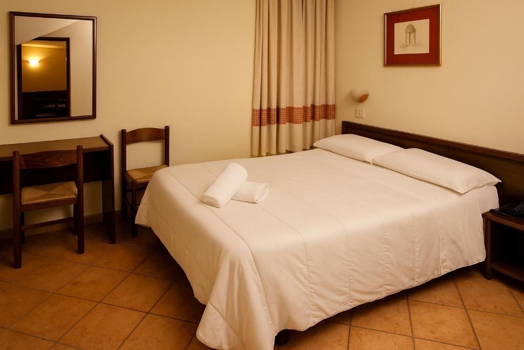 Postel nebo postele na pokoji v ubytování Albergo Reale