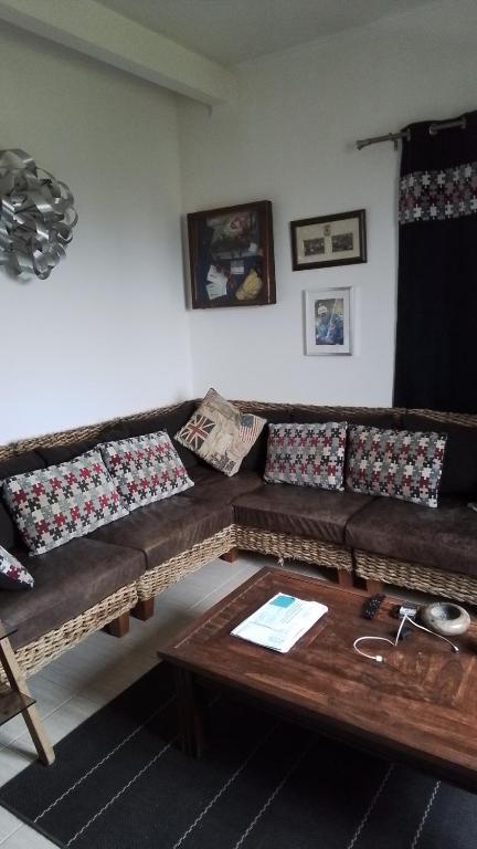 a living room with a couch and a table at Appart typique dans un chateau in Ajaccio