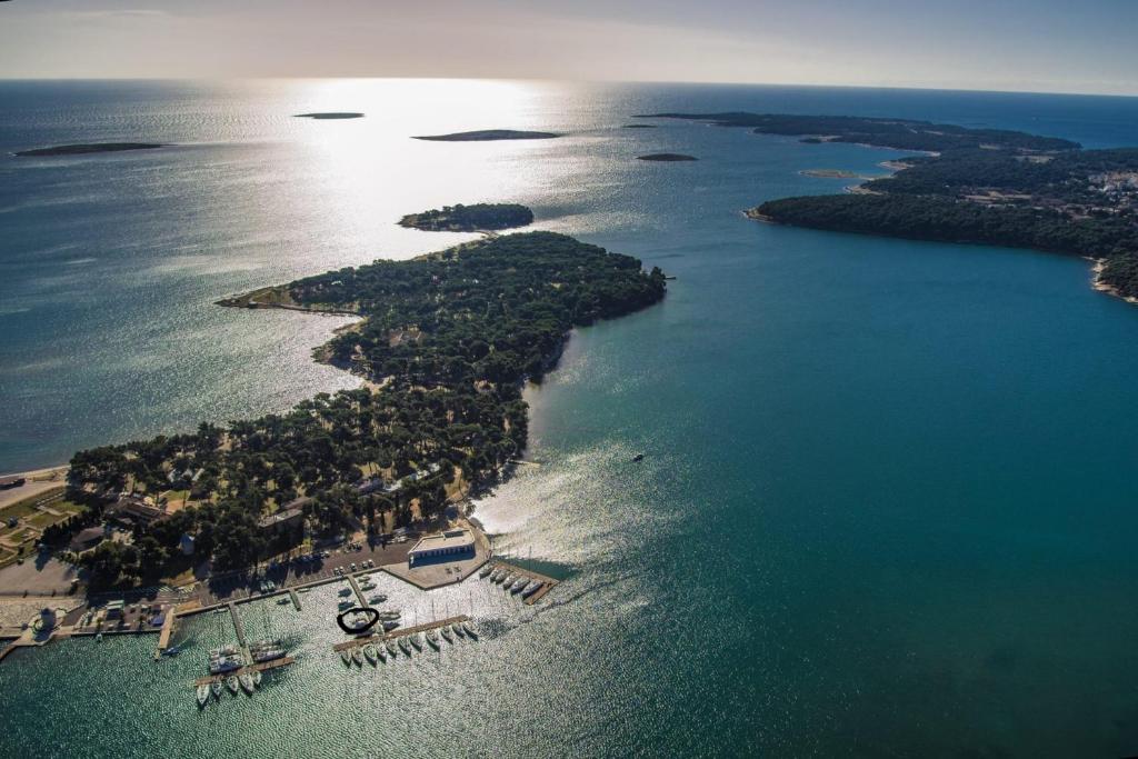 an aerial view of an island in the water at Sailboat on the sea in Medulin