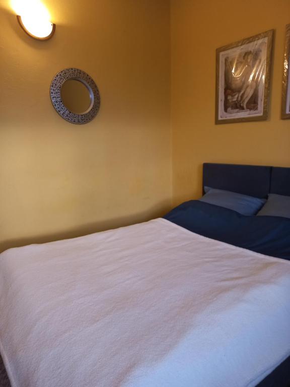 a bedroom with two beds and a mirror on the wall at Apart-Lux in Ciechocinek