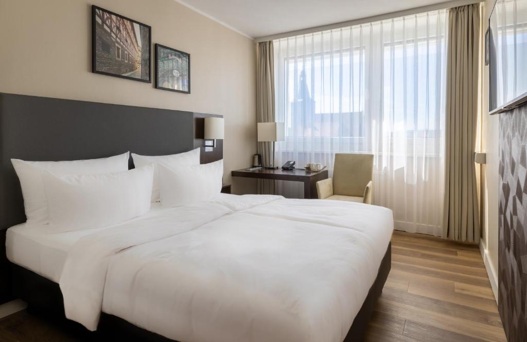 Postel nebo postele na pokoji v ubytování NYX Hotel Erfurt by Leonardo Hotels