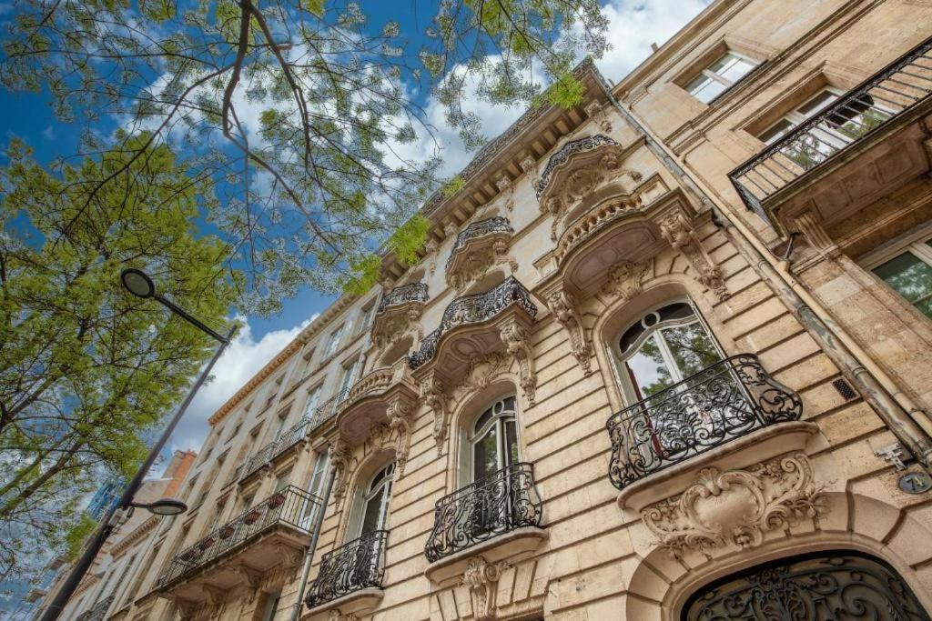 a tall building with balconies on the side of it at Appart en Hypercentre - Le Clemenceau in Bordeaux