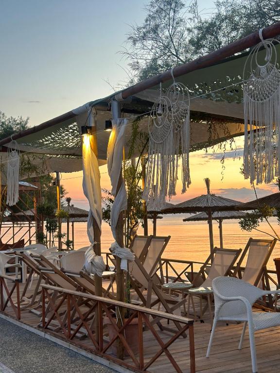 a group of chairs and umbrellas on a deck at Family Beach apartment in Perea