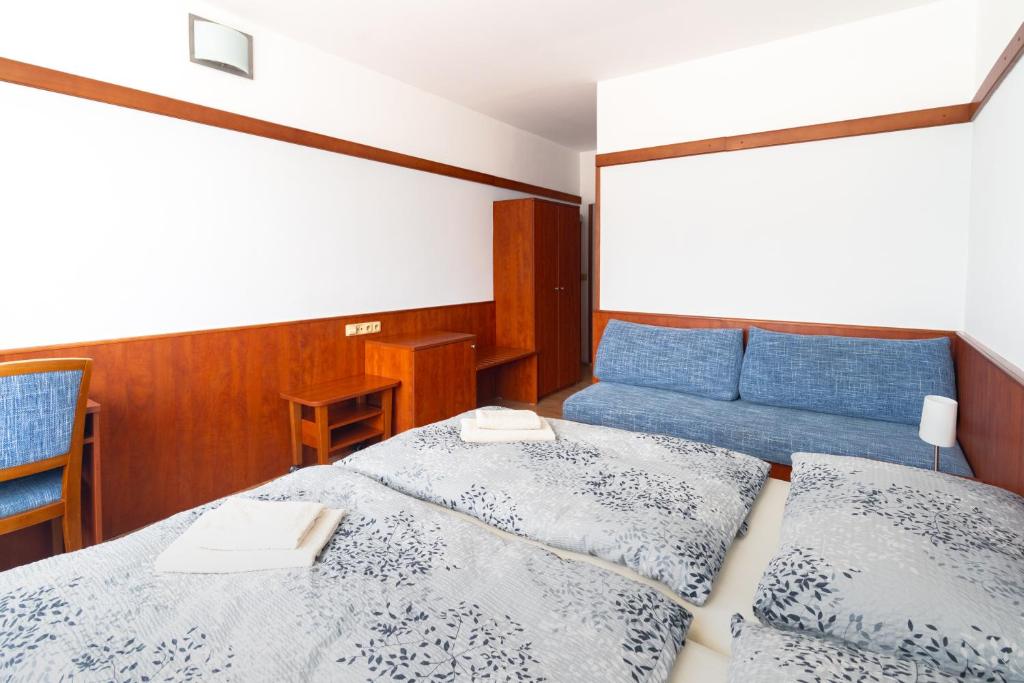 Postel nebo postele na pokoji v ubytování Hotel Macocha