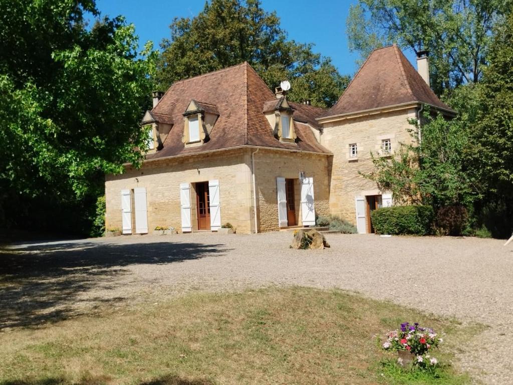 an old stone house with a large yard at Le Manoir de la Feuillade in Carsac-Aillac