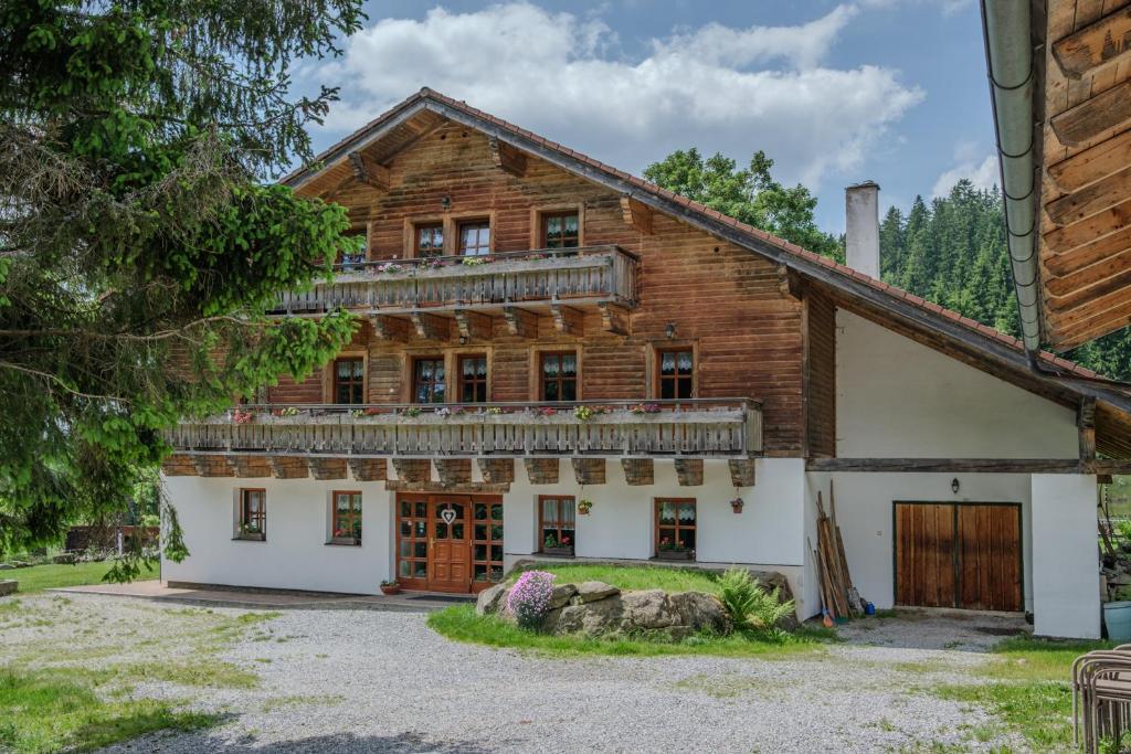 an old wooden house with a balcony at Pension Klose in Kubova Huť