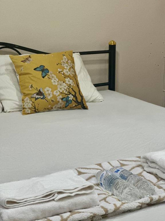 a bed with two bottles of water on it at Yoga Bed and Breakfast in Chiang Mai
