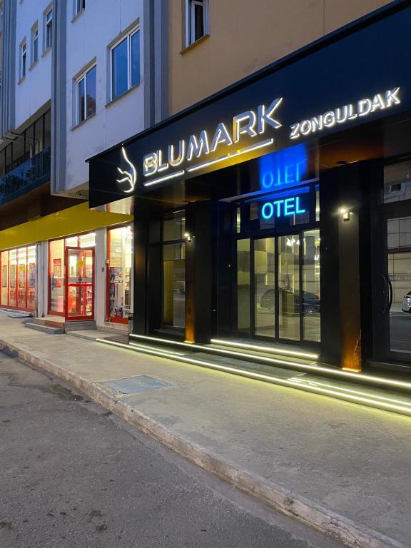 a building with a sign on the side of a street at BLU MARK Otel in Kozlu