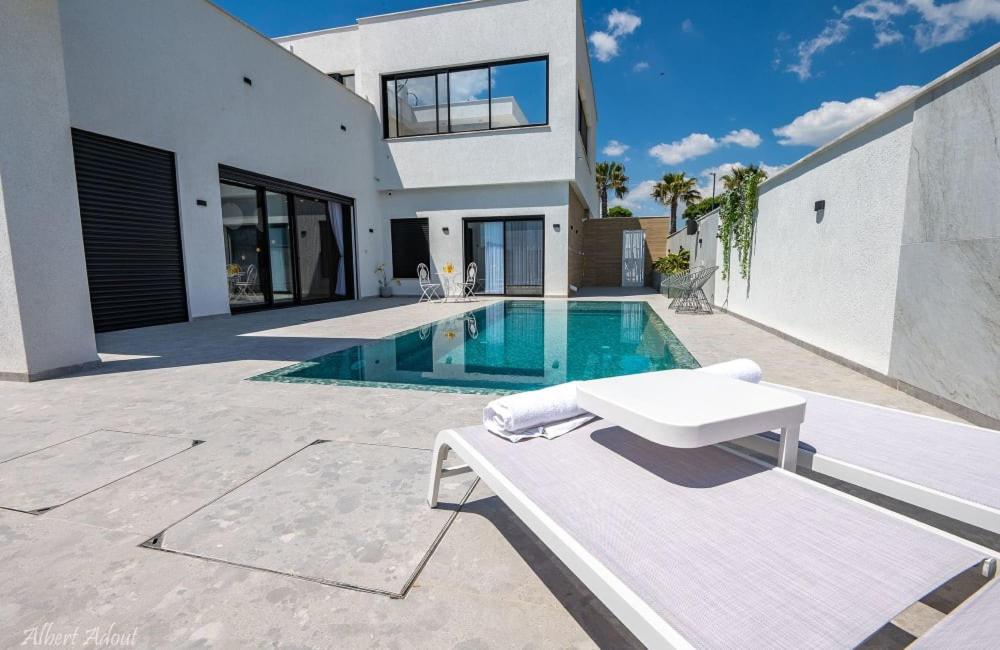 a villa with a swimming pool and a house at סבן דרים - Seven Dream - וילת 5 חדרי שינה ובריכה פרטית in Shahar
