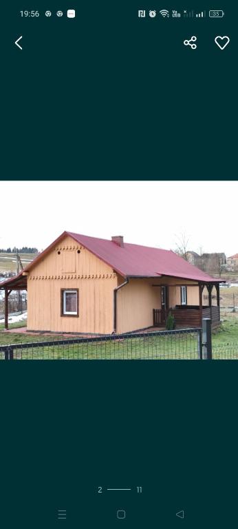 a picture of a house with a barn at Agroturystyka pod skałką u Marzeny 