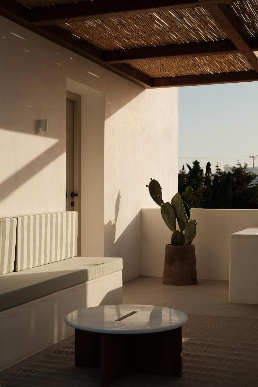 a living room with a table and a cactus at Mazi Paros in Aliki
