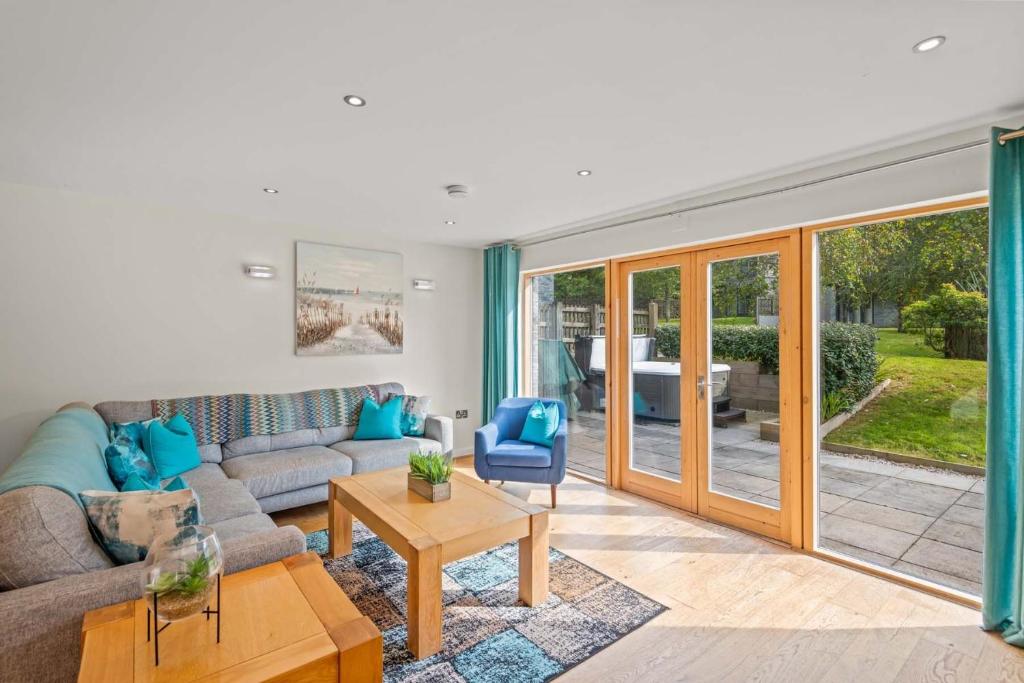 a living room with a couch and a table at House 4 in Looe
