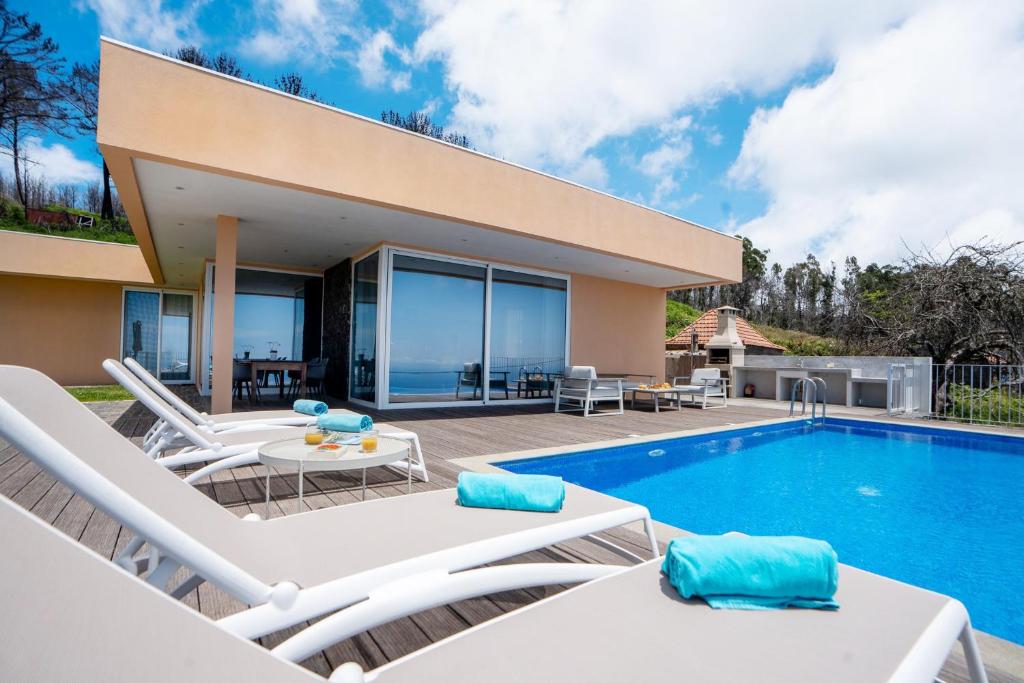 a villa with a swimming pool and a patio at Casa Luz - Stunning Family Home by LovelyStay in Prazeres