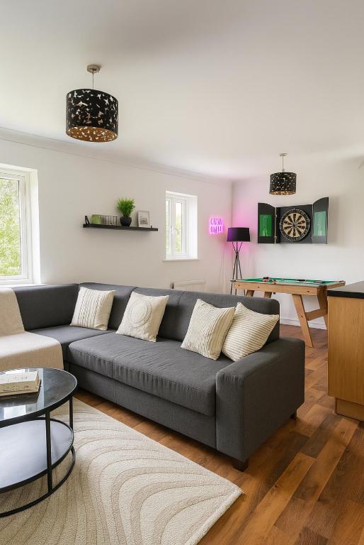 a living room with a couch and a table at Modern 2BR Aprt Sleeps 6 Parking ,Pet Welcome in Timperley