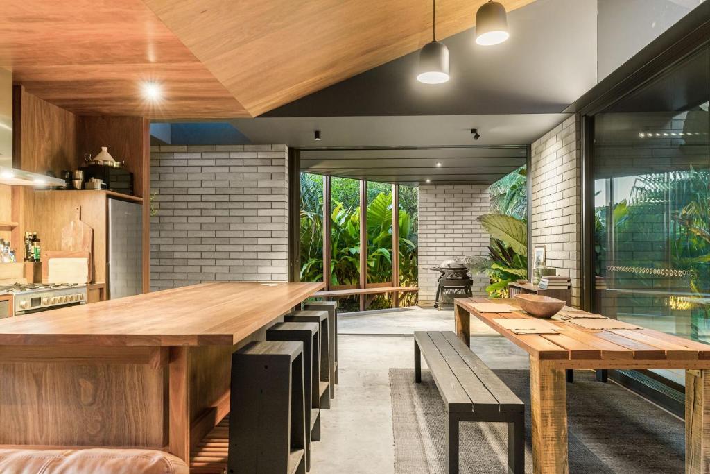 eine Küche mit großem Holztisch und Bänken in der Unterkunft Muli Muli in Ocean Shores