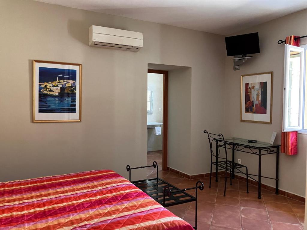 Postel nebo postele na pokoji v ubytování Hotel Du Vignoble