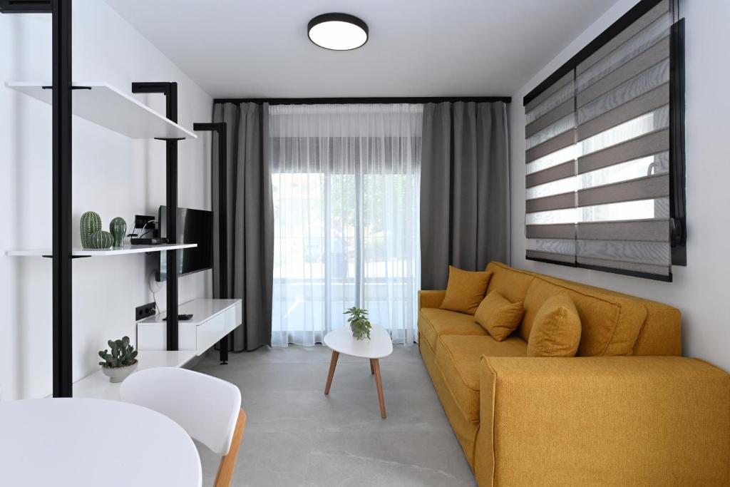a living room with a couch and a table at Agios Nikolaos Villas in Agios Nikolaos