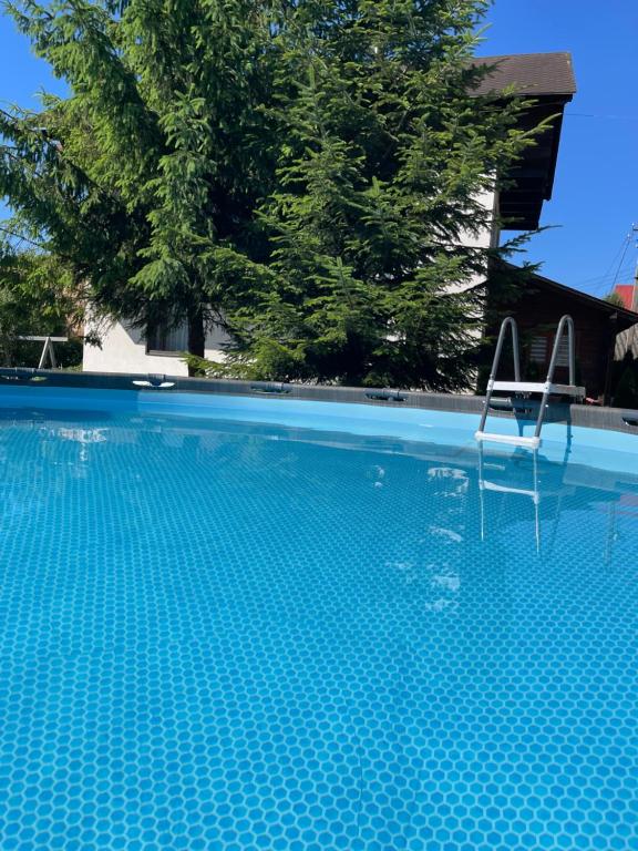 a swimming pool with a chair sitting in it at Тіна in Slavske