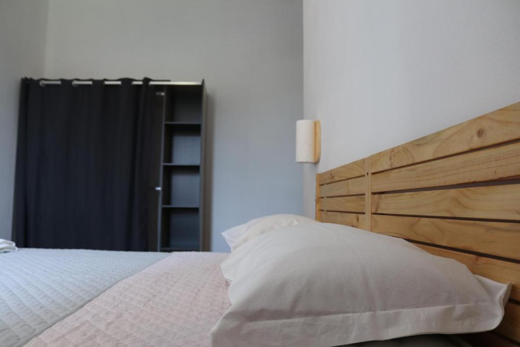 a bedroom with a bed with a wooden headboard at Du' passi dal centro in Arezzo