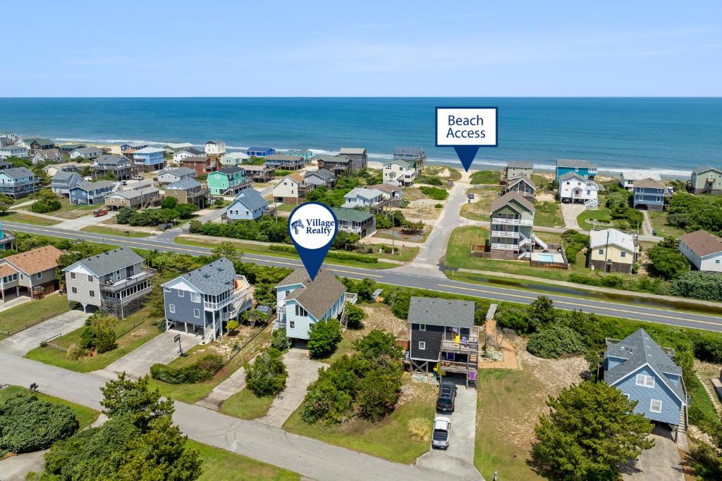 an aerial view of a residential neighborhood with a sign that reads beach access at RoSea Retreat in Nags Head