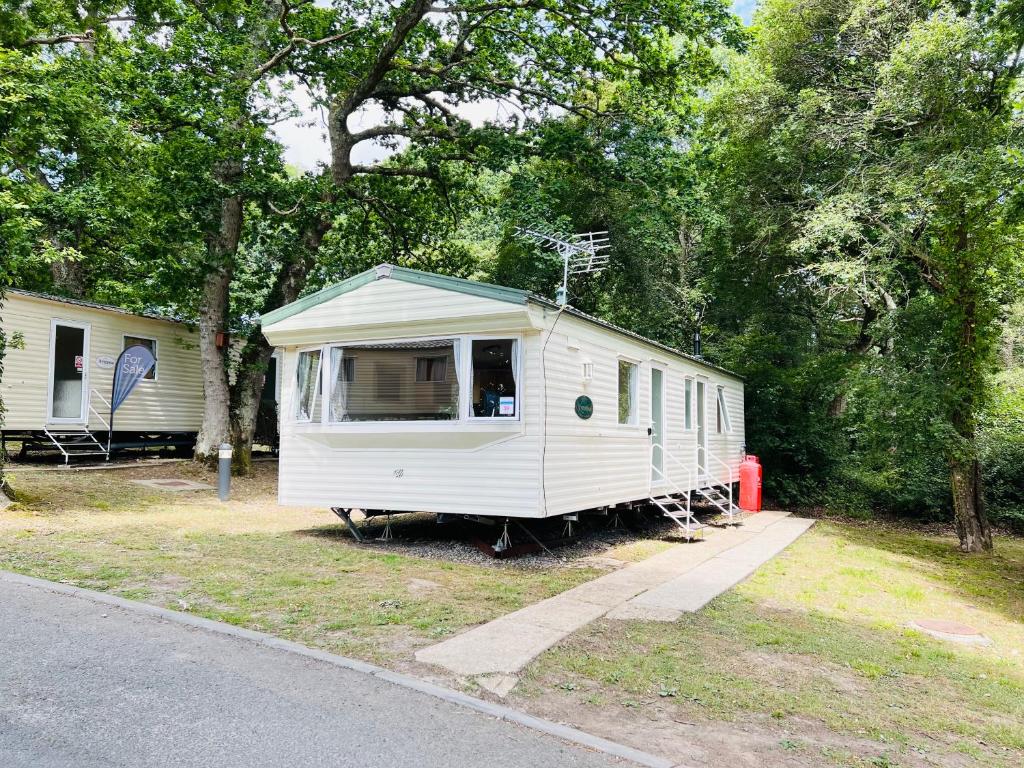 a small white trailer sitting on the side of a road at 2 Bedroom Caravan GW39, Thorness Bay, Isle of Wight, Dog Friendly in Porchfield