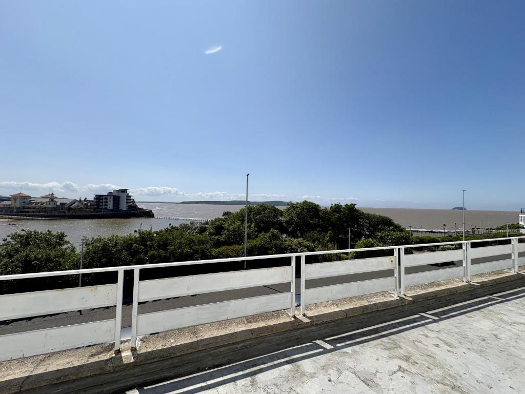 a bridge over a body of water with a boat at Savoy Hotel in Weston-super-Mare