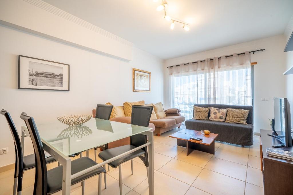 a living room with a table and a couch at BeGuest City Center in Olhão in Olhão