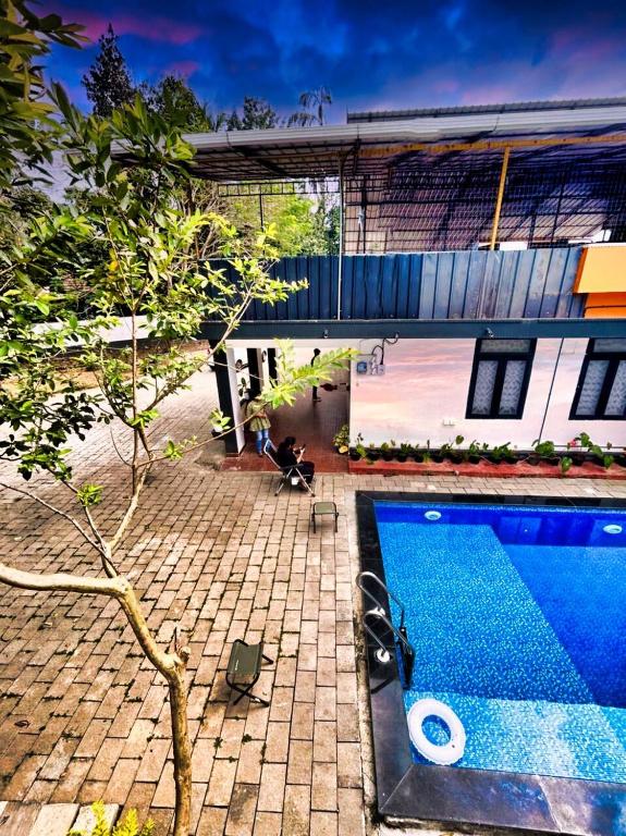 a house with a swimming pool next to a building at 1 Forest Soul - Forest Side Retreat with Pool in Batheri