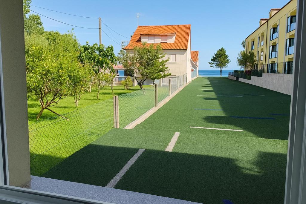 a view of a tennis court from a window at Pes Na Area Fisterra 01 in San Martín de Arriba