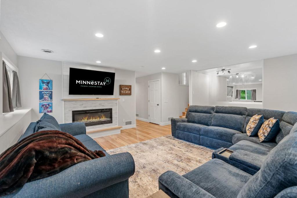 a living room with two blue couches and a fireplace at Meadows Retreat in Saint Michael