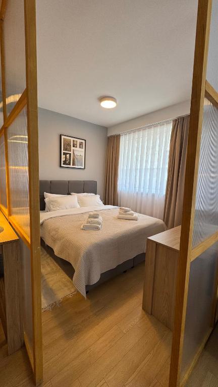 Postel nebo postele na pokoji v ubytování Kaneo Central Apartments