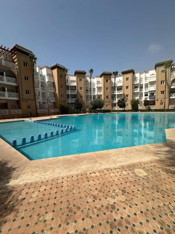 a large swimming pool in front of some buildings at Casa Amy in Mohammedia