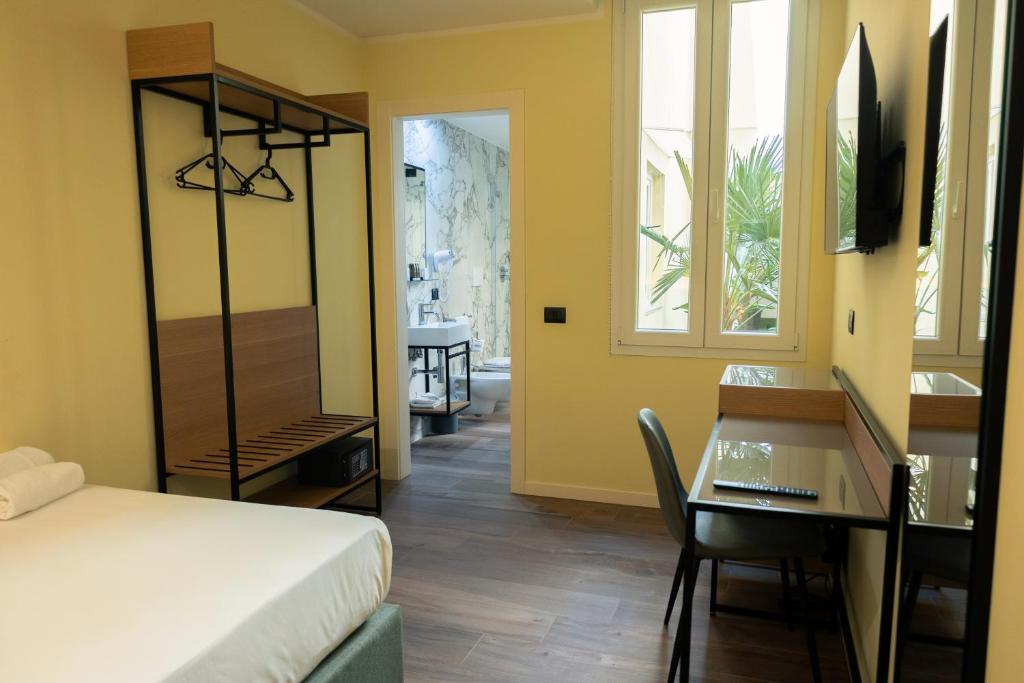 Postel nebo postele na pokoji v ubytování JR Hotels Hermes Firenze
