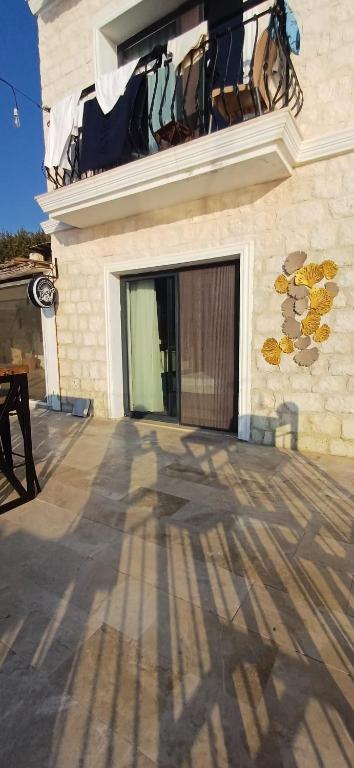 a brick building with a door and a balcony at Gümüş Yazar Hotel in Kaş