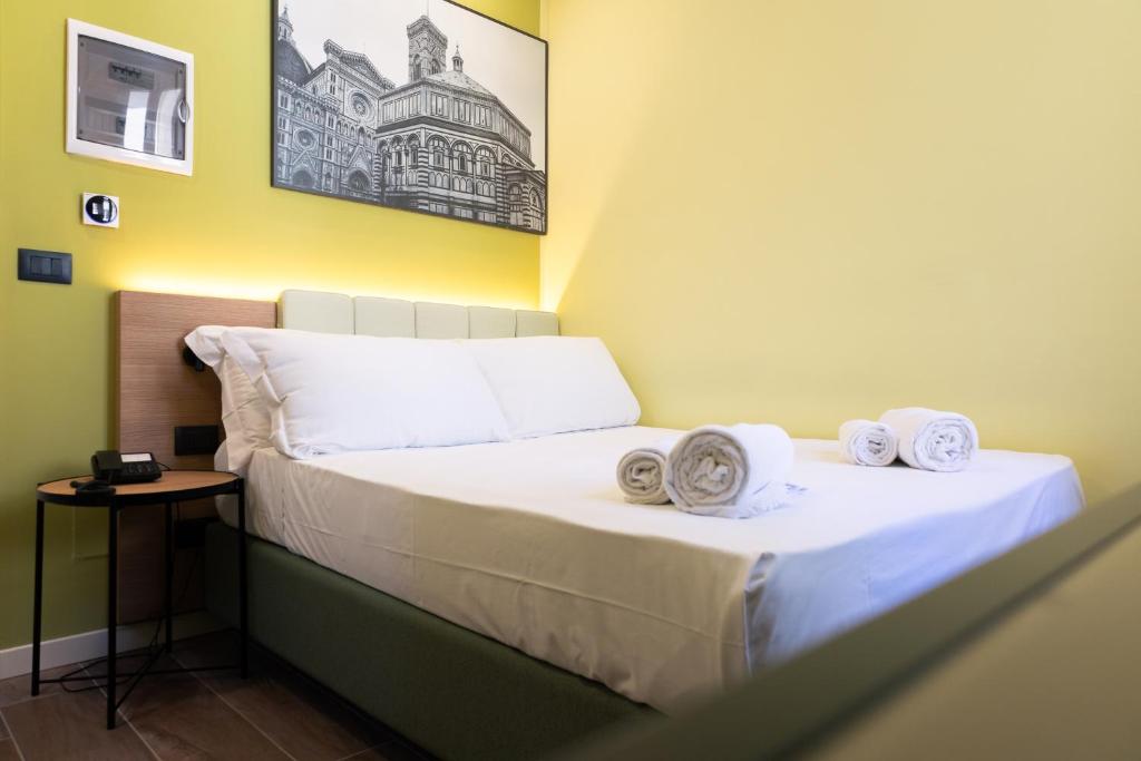 Postel nebo postele na pokoji v ubytování JR Hotels Hermes Firenze