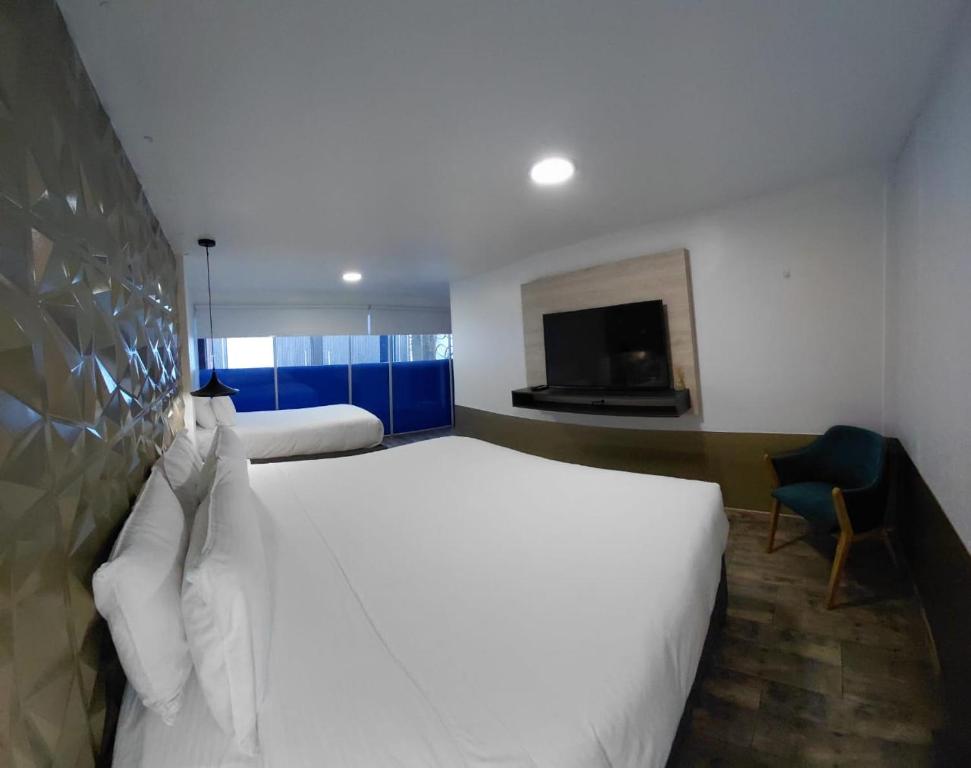 Postel nebo postele na pokoji v ubytování Hotel American Visa Normandia