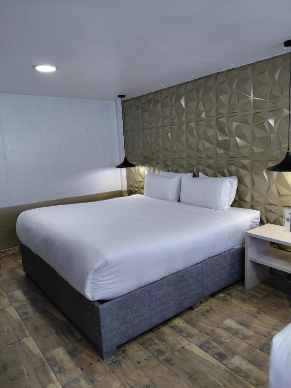 Postel nebo postele na pokoji v ubytování Hotel American Visa Normandia