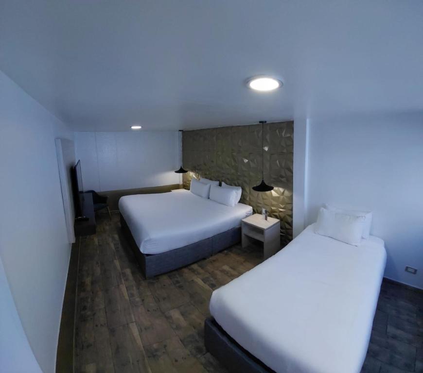 Postel nebo postele na pokoji v ubytování Hotel American Visa Normandia