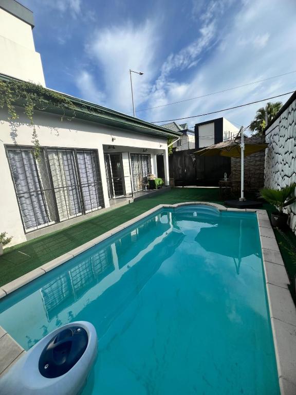 a swimming pool in front of a house at Villa Bonapriso with pool in Kofa