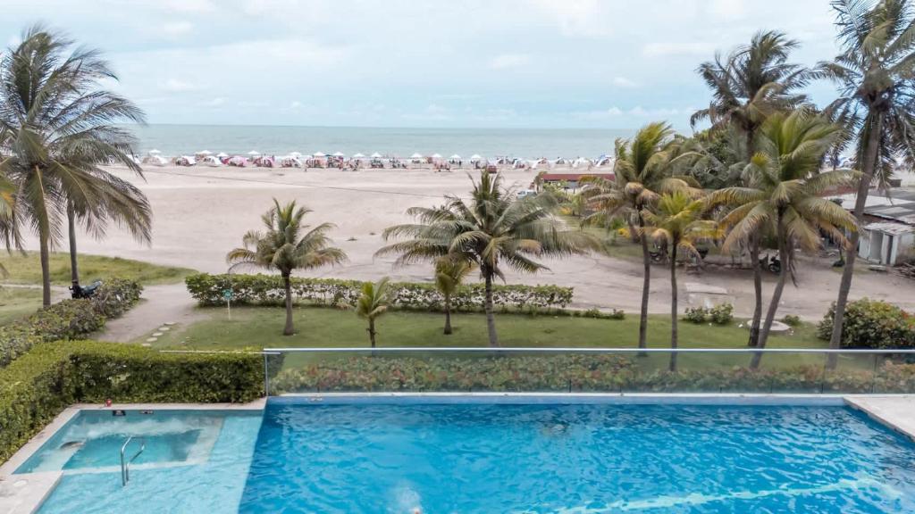 a view of the beach from the balcony of a resort at Morros Vitri Beachfront By Huespedia in Bolivar