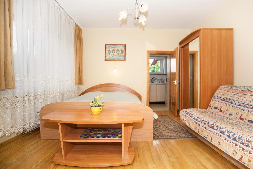 a hotel room with a bed and a table at Holiday Palanga in Palanga