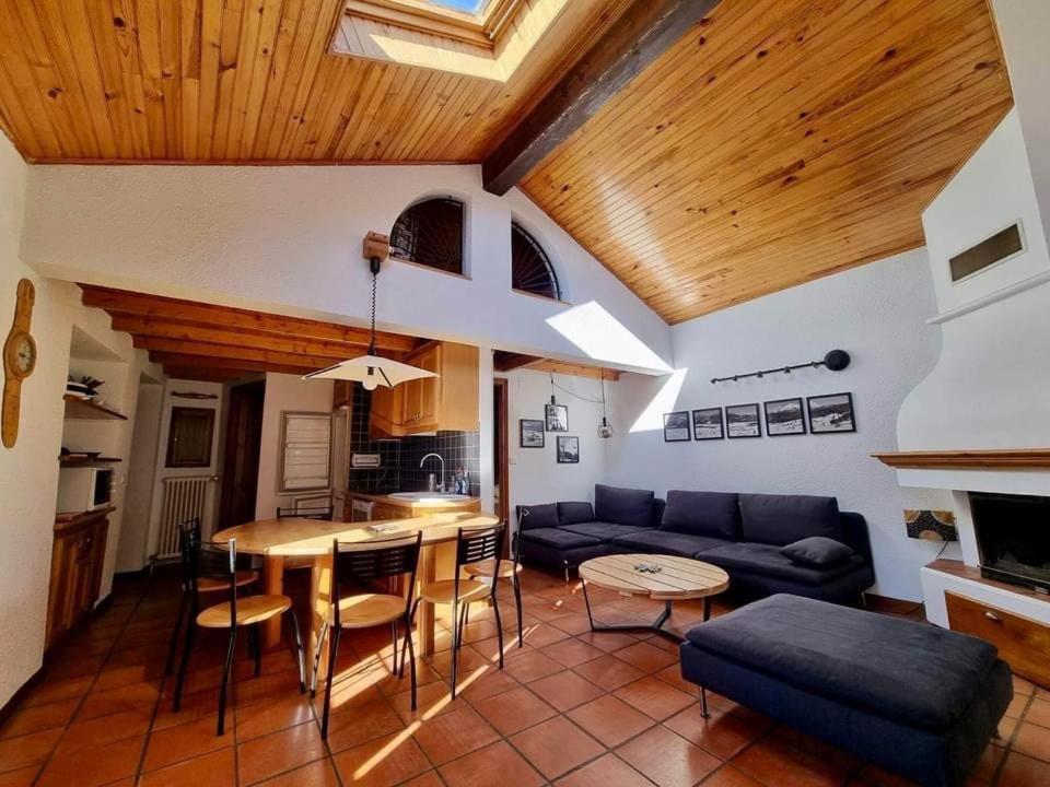 a living room with a couch and a table at Appartement Les Angles villages in Les Angles