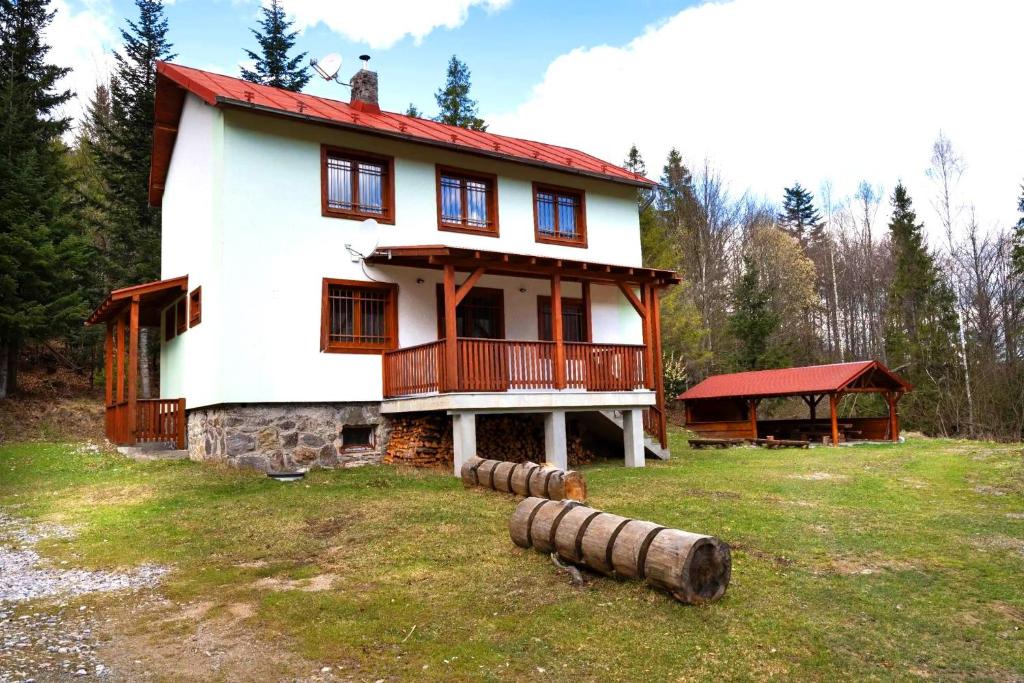 a large white house with a red roof at Chata LANOVKA - Vojtechova samota in Spišská Nová Ves