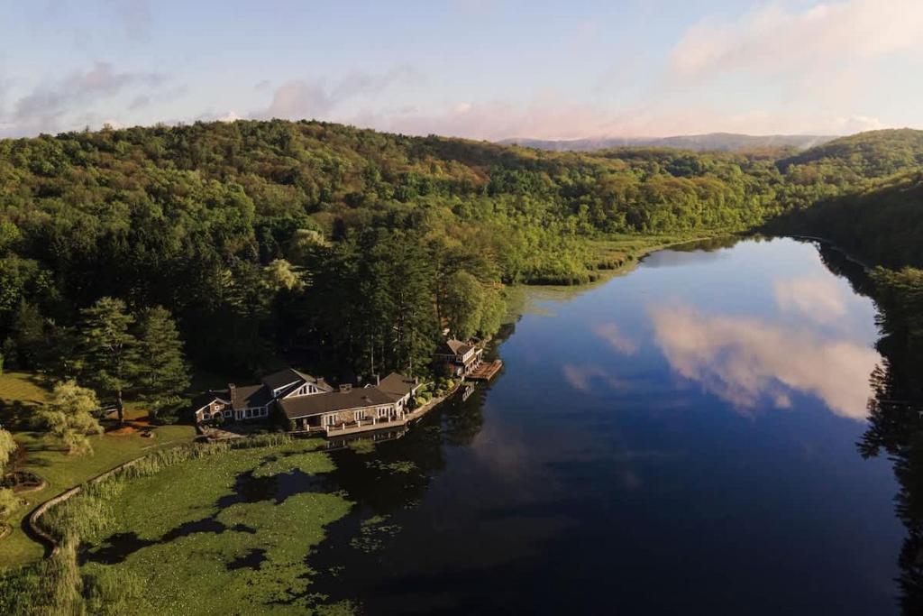an aerial view of a house on a river at Private 37 Acre Lake Estate On 164 Acres - 11 Br in Highland