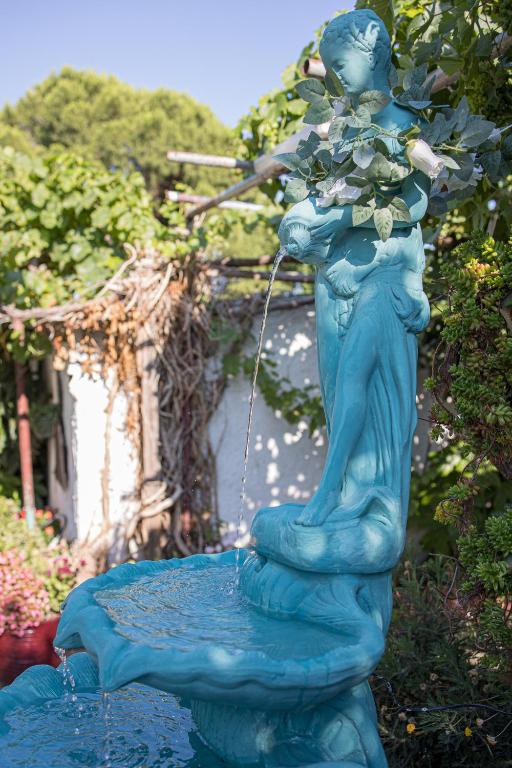 a statue of a woman standing on top of a fountain at Gatzea Eden Garden - DELUXE Δίκλινο δωμάτιο in Kato Gatzea