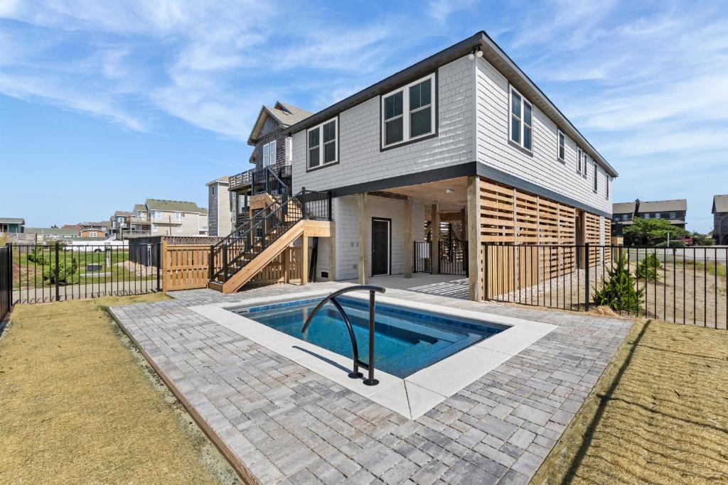 a house with a swimming pool in the backyard at Salt Box in Nags Head