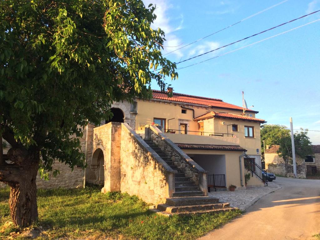 a house with a staircase in front of it at Apartment Anamarija in Poreč