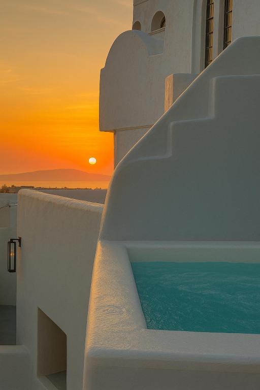 a sunset over the ocean on the side of a building at Suntora in Pyrgos